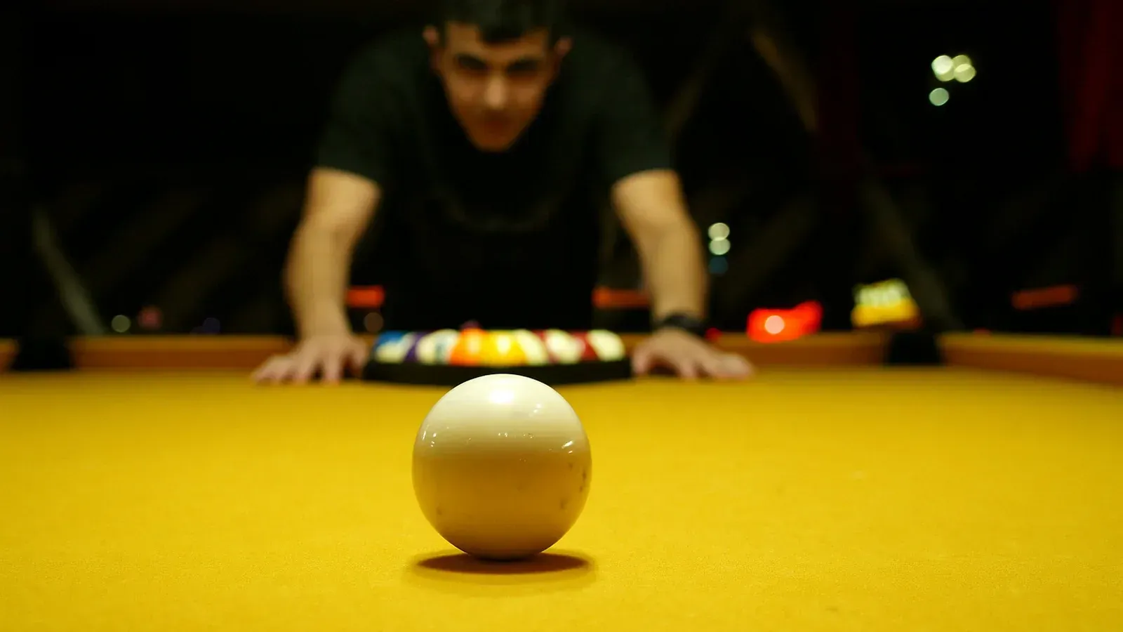 Original post image of a player lining up a shot on a yellow pool table